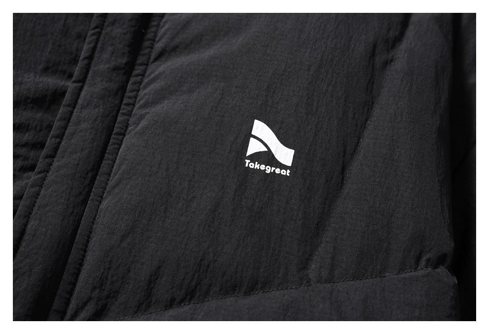 Close-up of the black jacket's white Takegreat chest logo and textured fabric.