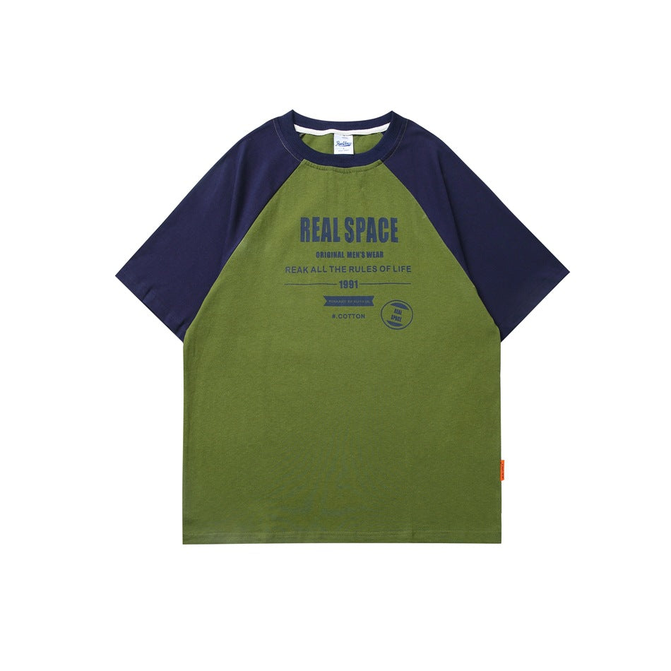 Green T-shirt with navy raglan short sleeves and collar, front view with navy REAL SPACE text graphic