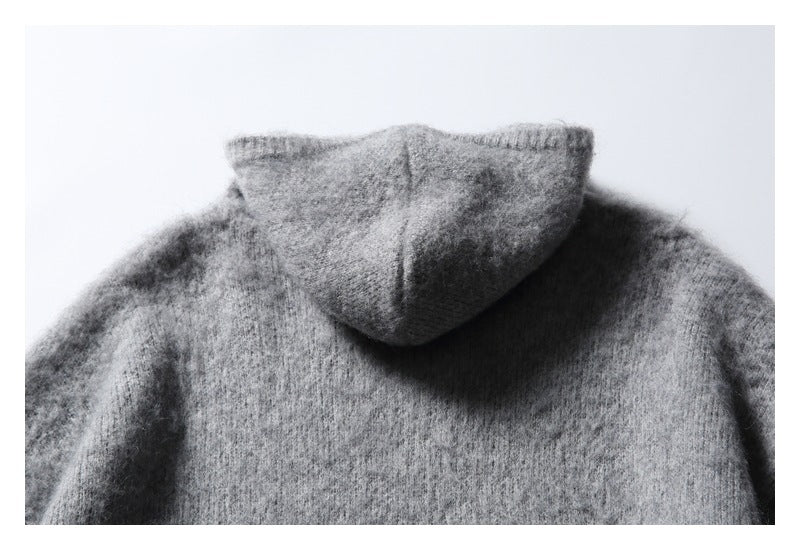 Close-up of the back of a gray knit hood and upper shoulders.
