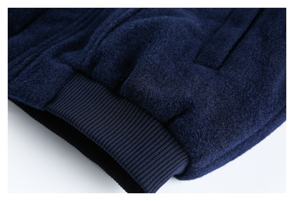 Close-up of a dark navy garment showing a ribbed cuff and nearby seam details.