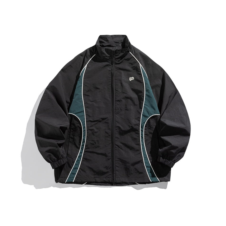 Black zip-up stand-collar jacket with teal side panels, white piping, elastic cuffs and a small chest logo, front view