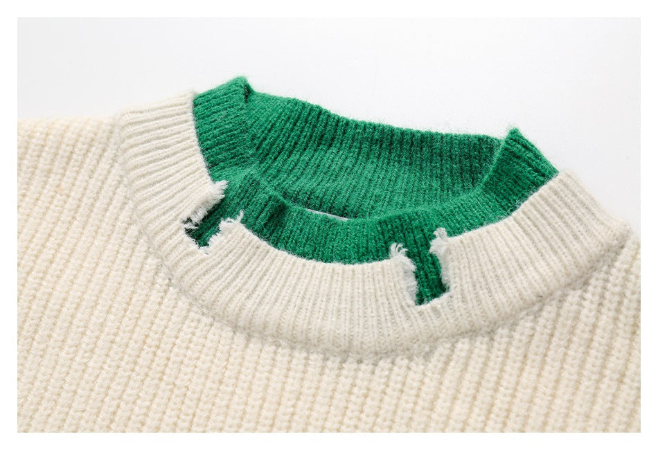 Close-up of the ivory sweater’s ribbed neckline layered over a green knit collar.