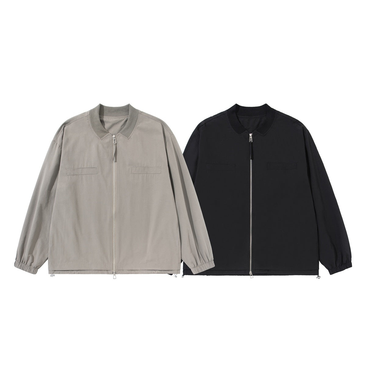 Front view of two zip jackets, one taupe and one black, with ribbed collars and elastic cuffs.