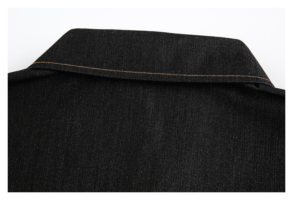 Close-up of a dark black garment collar with tan contrast stitching.