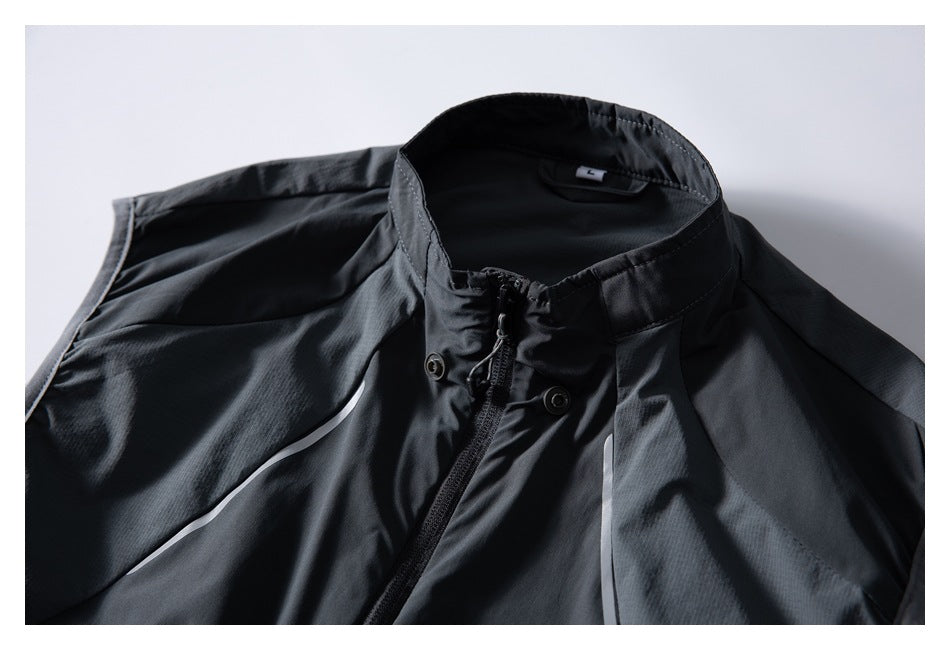 Close-up of the charcoal jacket's stand collar, front zipper, snap fasteners, and inner label.