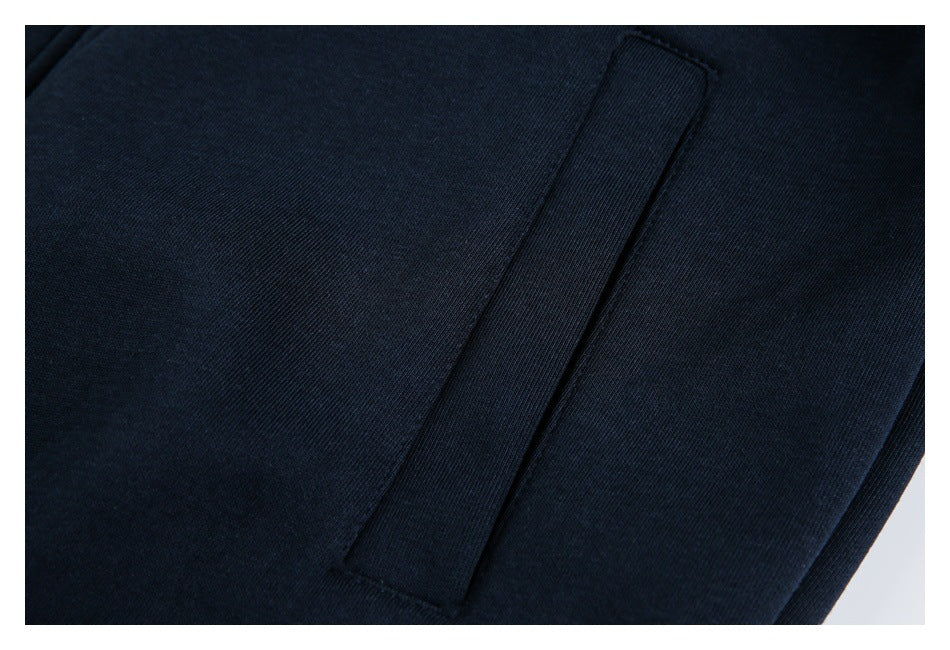Close-up of a narrow welt pocket on dark navy fabric.