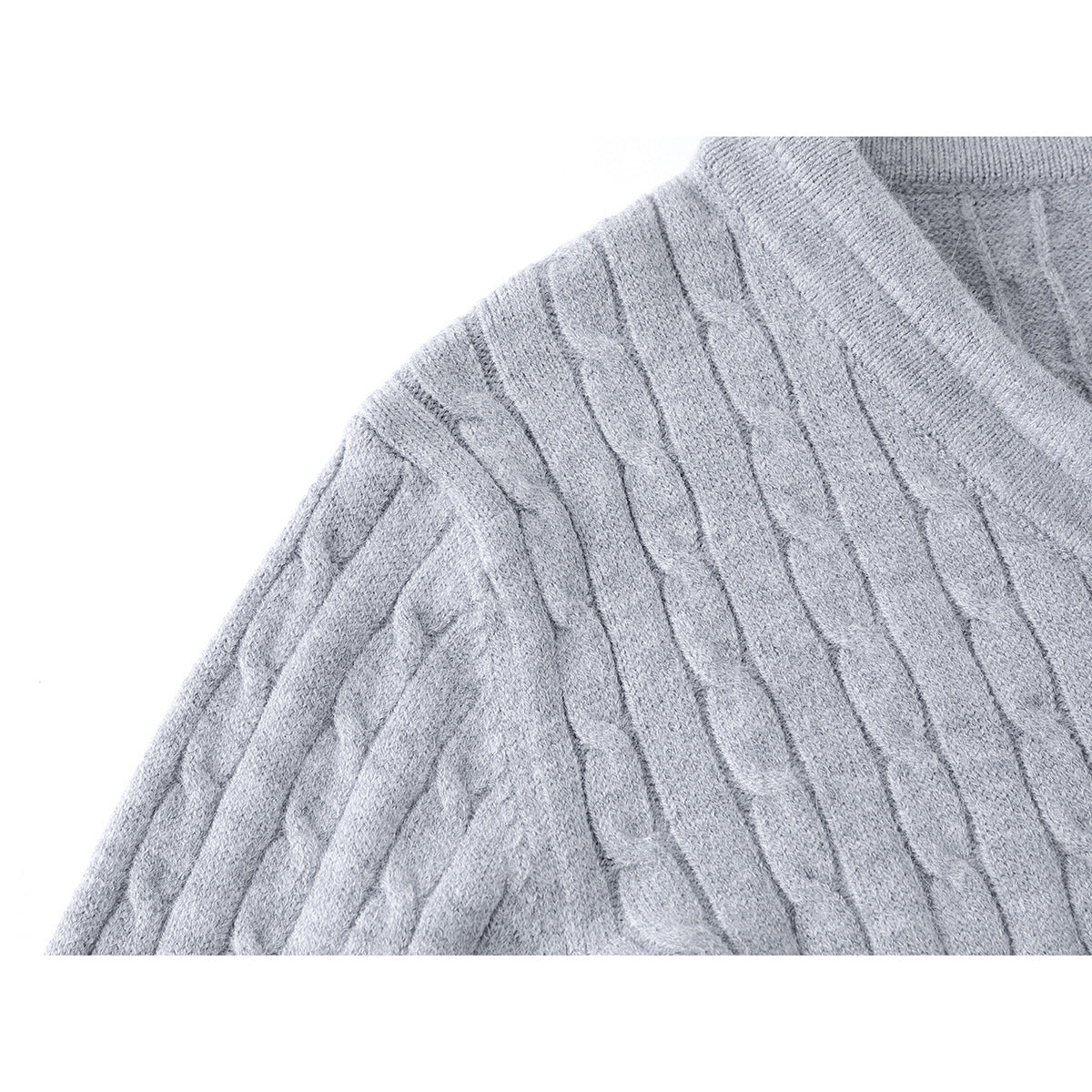 Close-up of the light gray sweater shoulder and raised cable-knit pattern.
