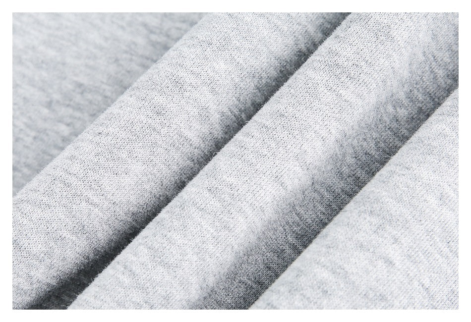 Macro view of the light gray heathered knit fabric.