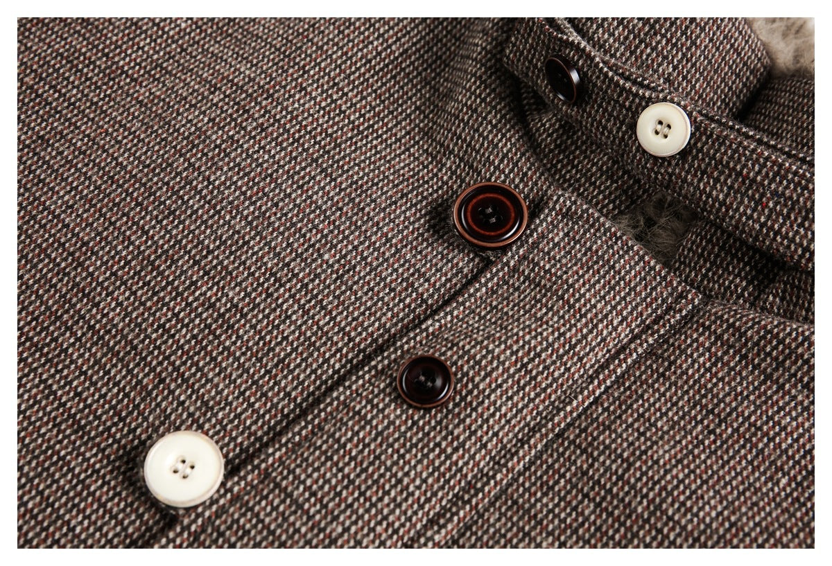 Close-up of the coat's brown patterned fabric, front placket, and dark and ivory buttons.
