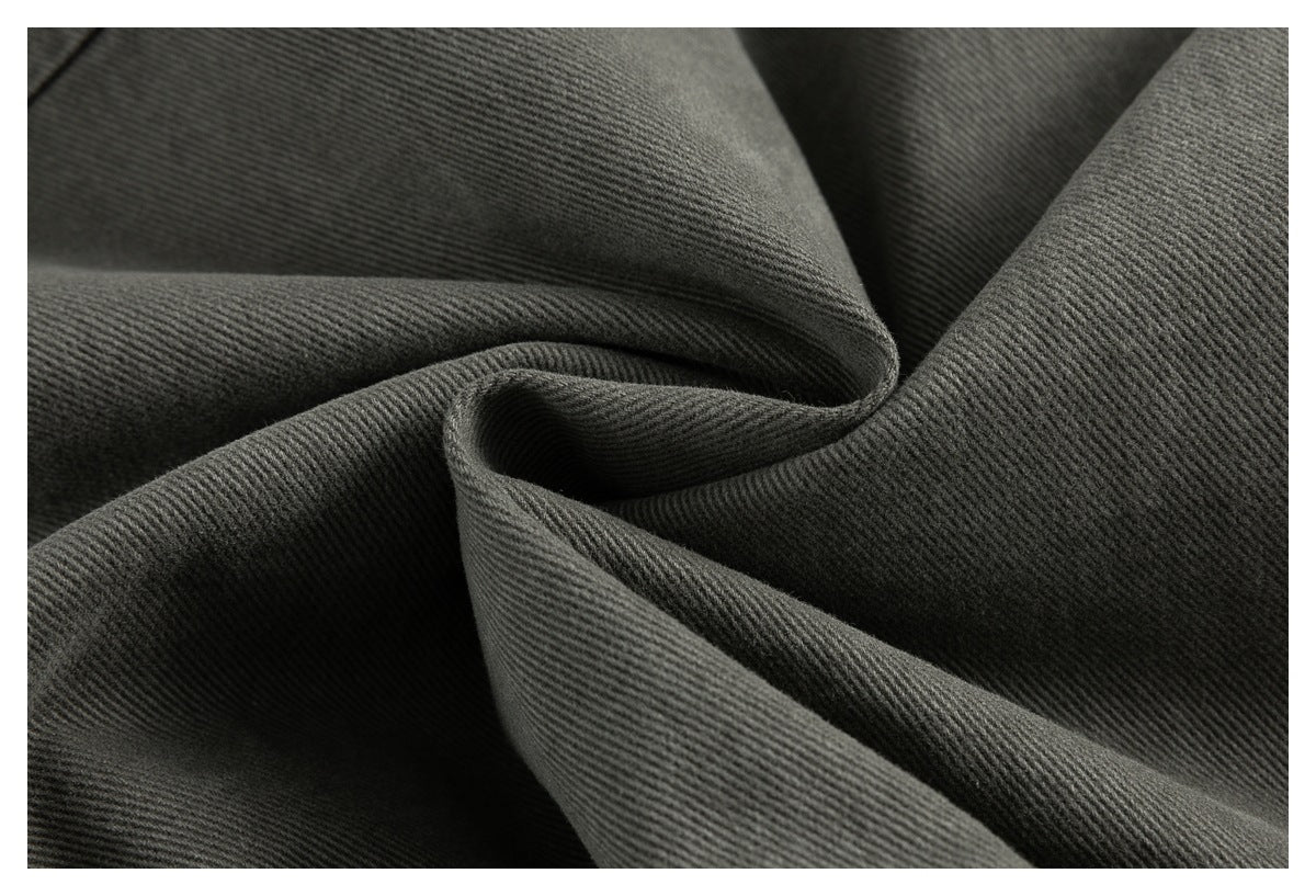 Extreme close-up of the olive-gray fabric's diagonal twill texture and folds.