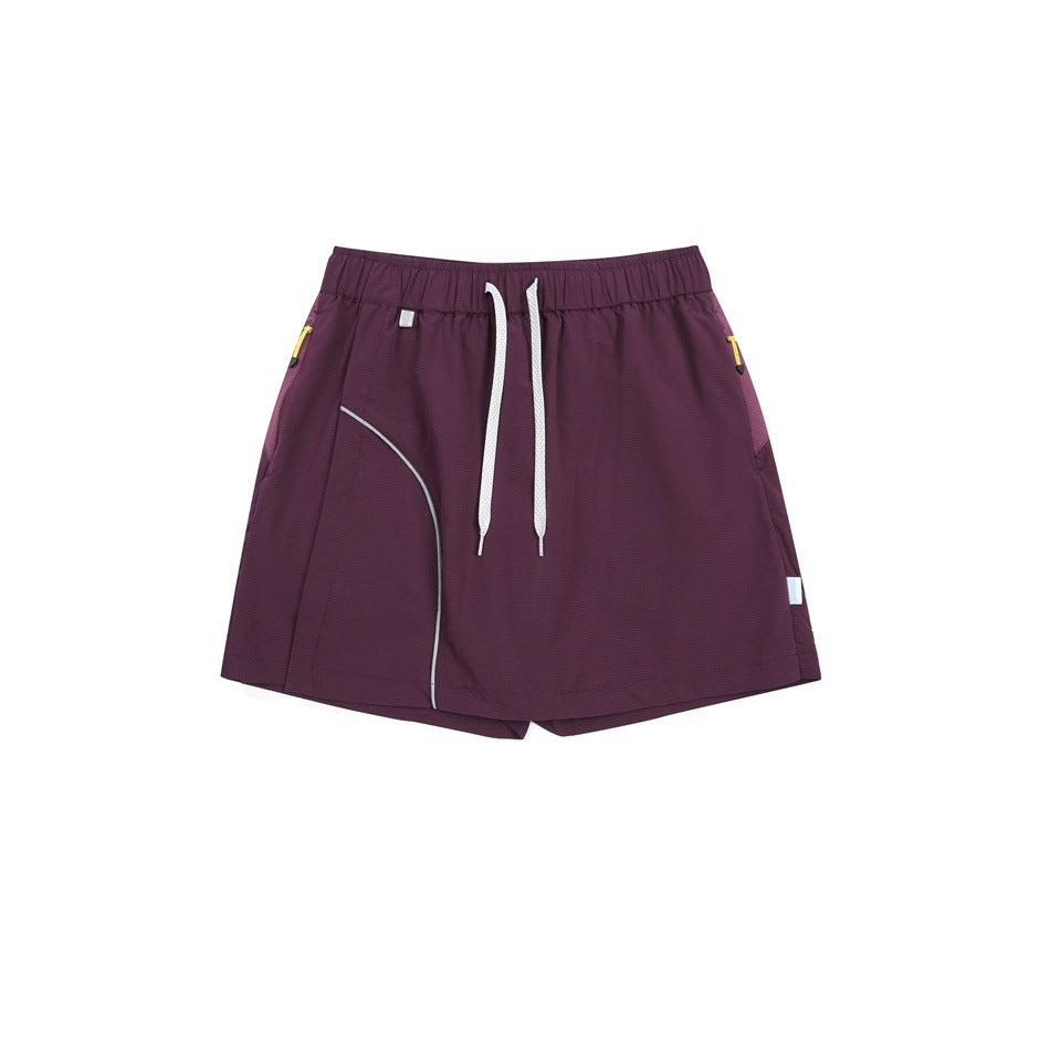 Purple skort flat lay with white drawstring, curved light-gray piping and yellow zipper pulls at the side pockets