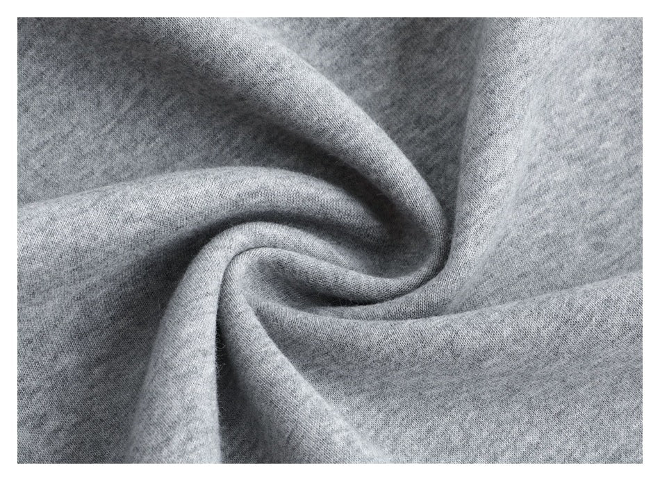 Close-up of the light gray fabric gathered into folds, showing its soft-looking surface.