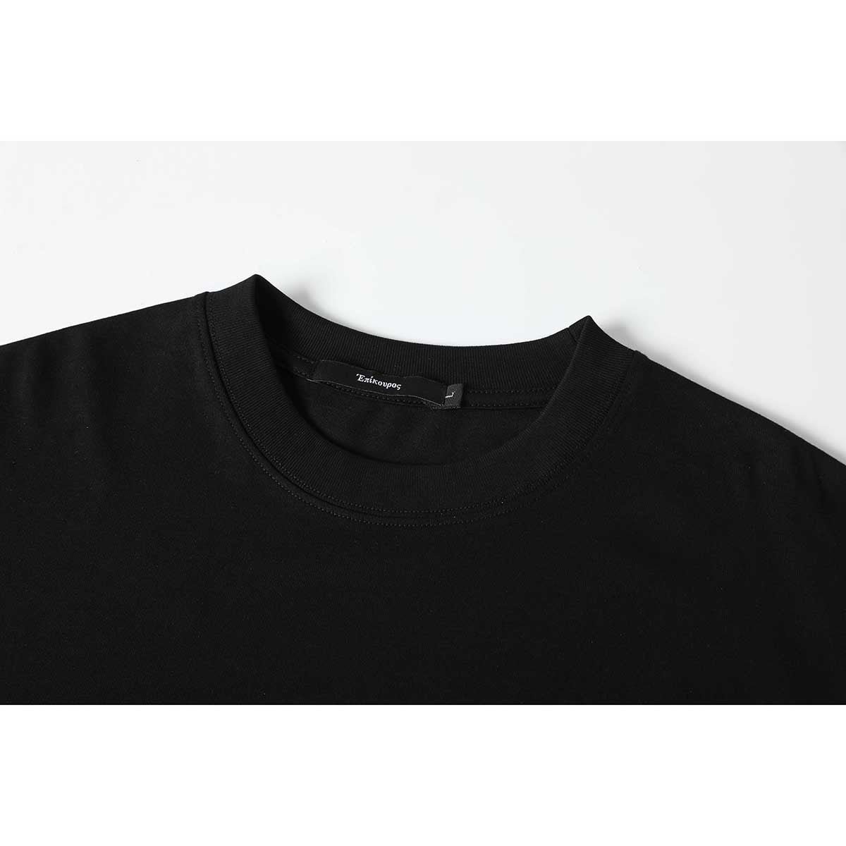 Close-up of a black T-shirt's ribbed crew neck and inner neck label.