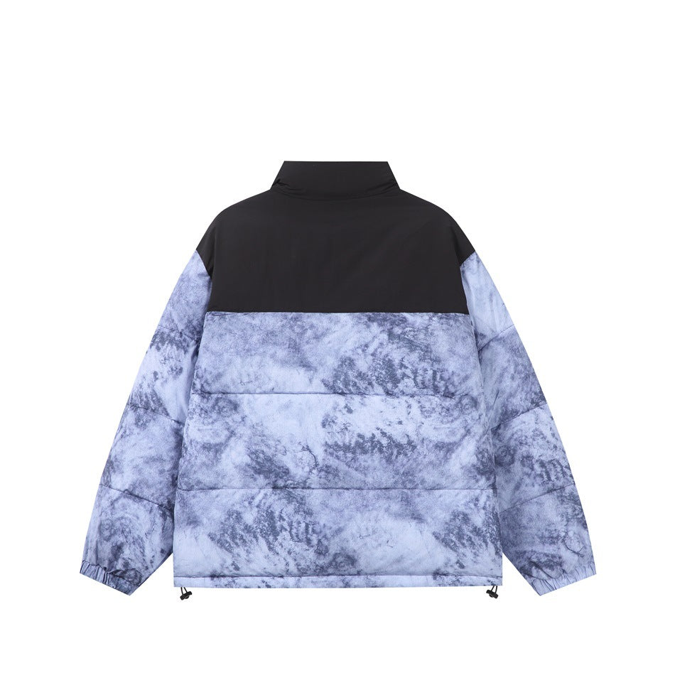 Back view of a black and pale blue-gray mottled puffer jacket with a high collar and adjustable hem.