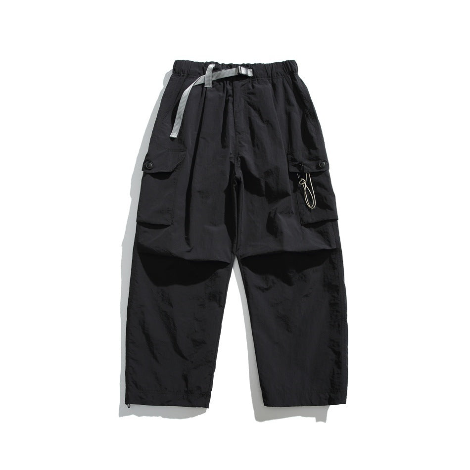 Black wide-leg cargo pants with gray buckle belt and flap side pockets, flat lay front view