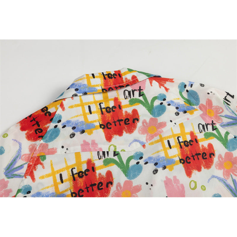 Close-up of the shirt's back collar and yoke in a colorful abstract print with black lettering.