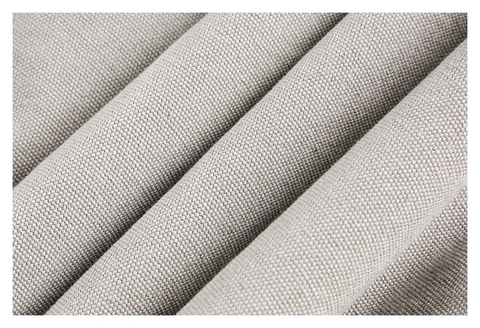 Close-up of the jacket's light taupe woven fabric folded into ridges.