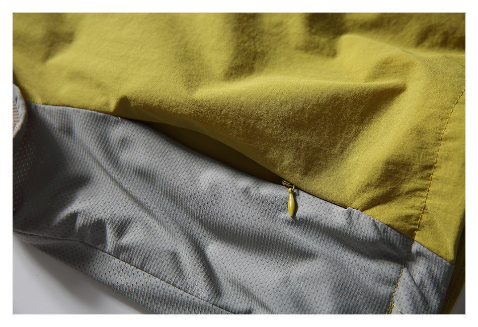 Close-up of a yellow zipper joining mustard-yellow fabric and gray perforated lining.