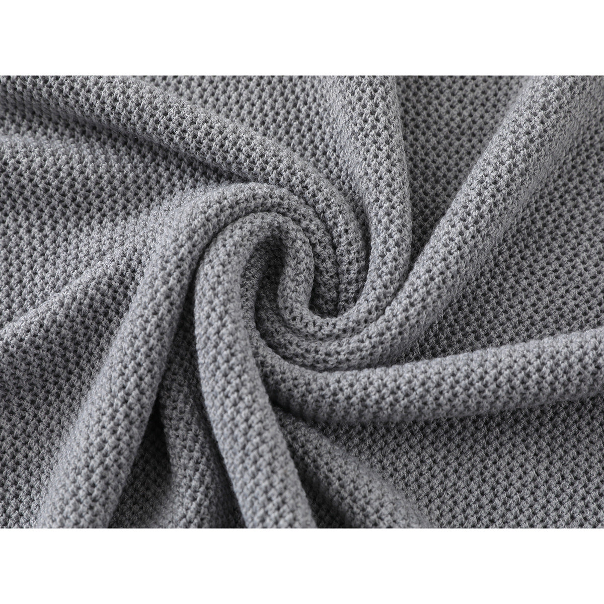 Close-up of the gray polo shirt's textured knit, draped to show the fabric's folds.
