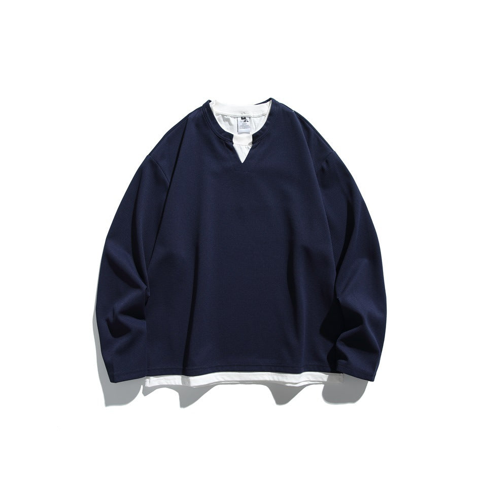 Navy blue long-sleeve textured pullover with white layered neckline and hem, flat lay front view