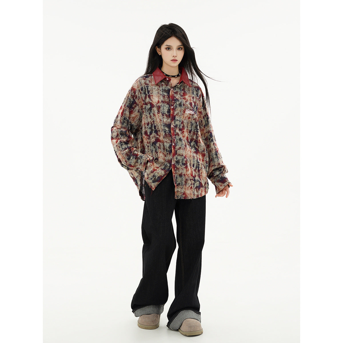 Full-length view of a model in a charcoal, red and cream abstract-print shirt with a dark red collar and wide-leg black