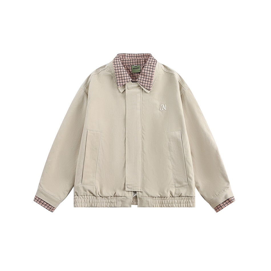 Apricot cropped jacket with pink and brown checked collar and cuffs, front placket, pockets and embroidered N