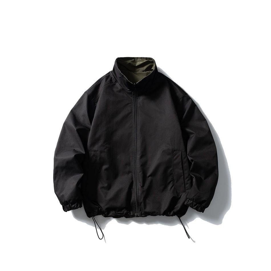 Black stand-collar zip jacket with olive inner collar, slanted side pockets and drawstring hem, flat lay
