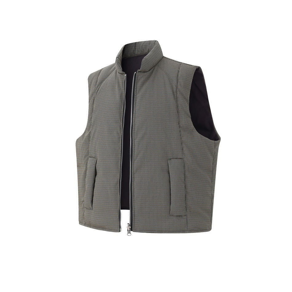 Angled view of houndstooth quilted vest with zipper partly open showing dark inner side