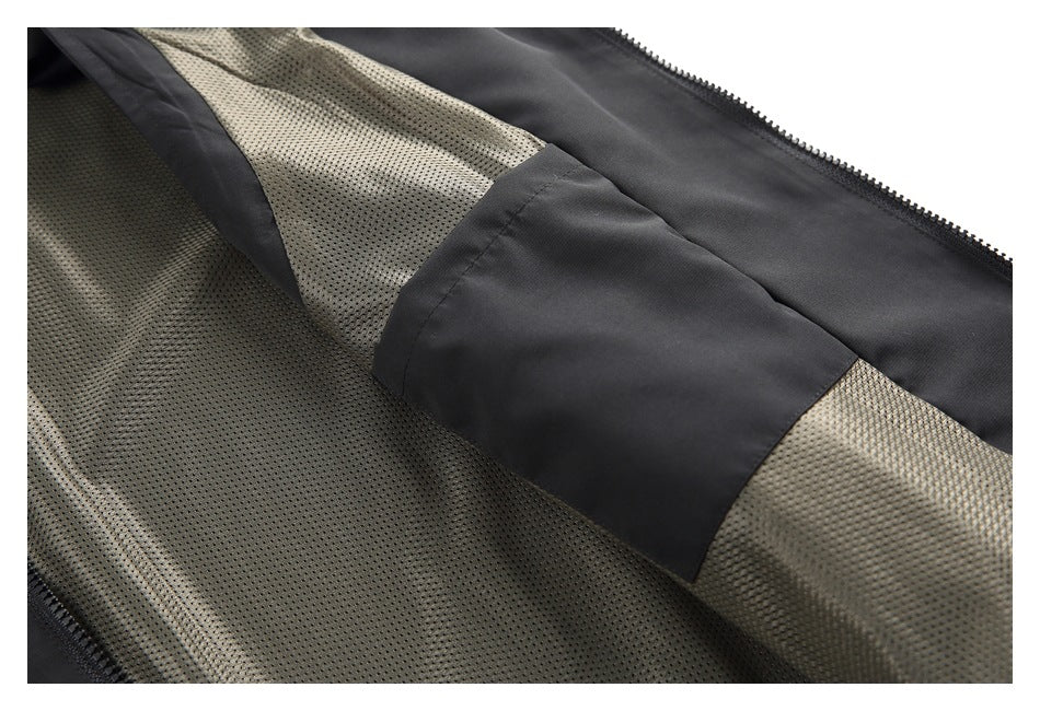 The black jacket is opened to show its gray perforated mesh lining and an interior pocket.