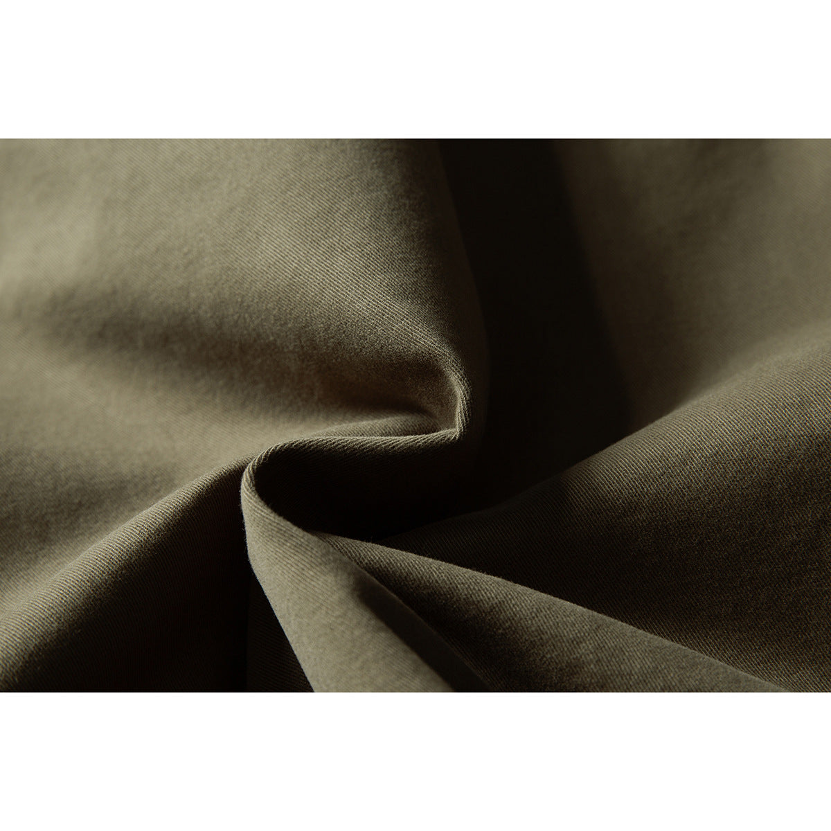 Close-up showing the olive jacket fabric's fine woven texture and folds.