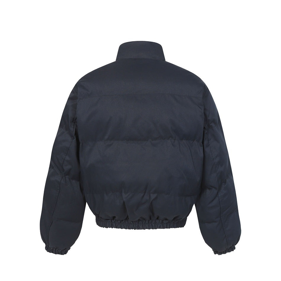 Back view of dark navy quilted puffer jacket with stand collar, elastic hem and elastic cuffs