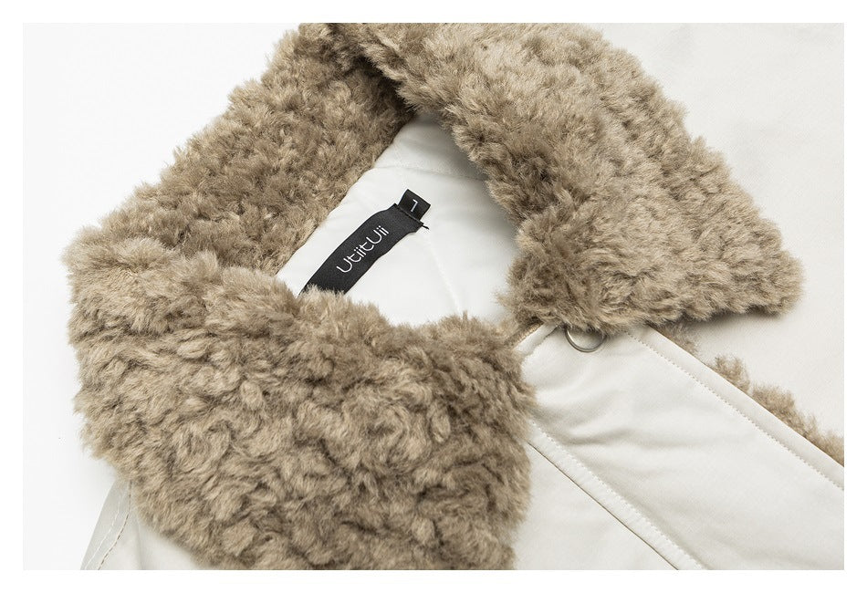 Close-up of a light beige jacket with a thick taupe faux-fur collar and inner brand label.