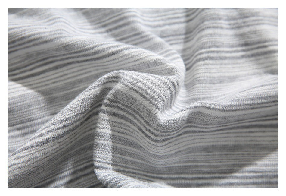 Close-up of softly draped gray and white striped knit fabric.
