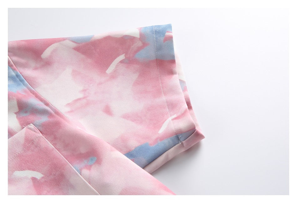 Close-up of a short sleeve and stitched cuff on the pink, white, and blue printed shirt.