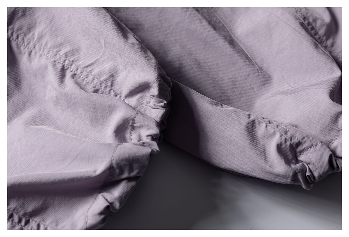 Close-up of lavender-gray garment seams and gathered elastic hems.