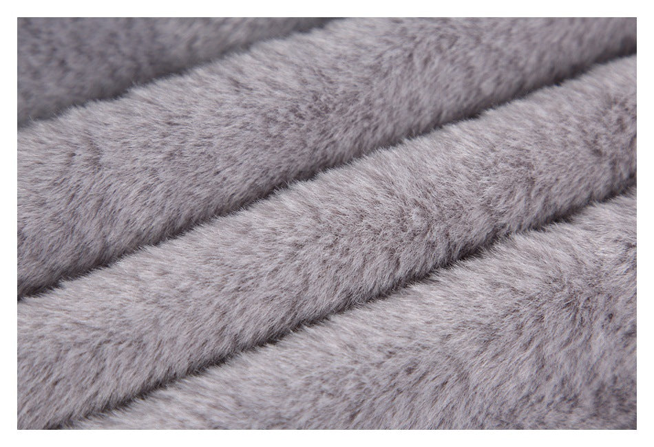Extreme close-up of the gray plush fabric, showing its soft, dense pile.
