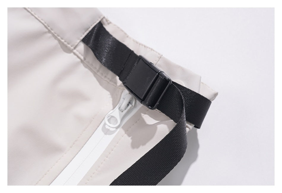 Close-up of the skirt's black adjustable webbing strap and buckle beside a white zipper.
