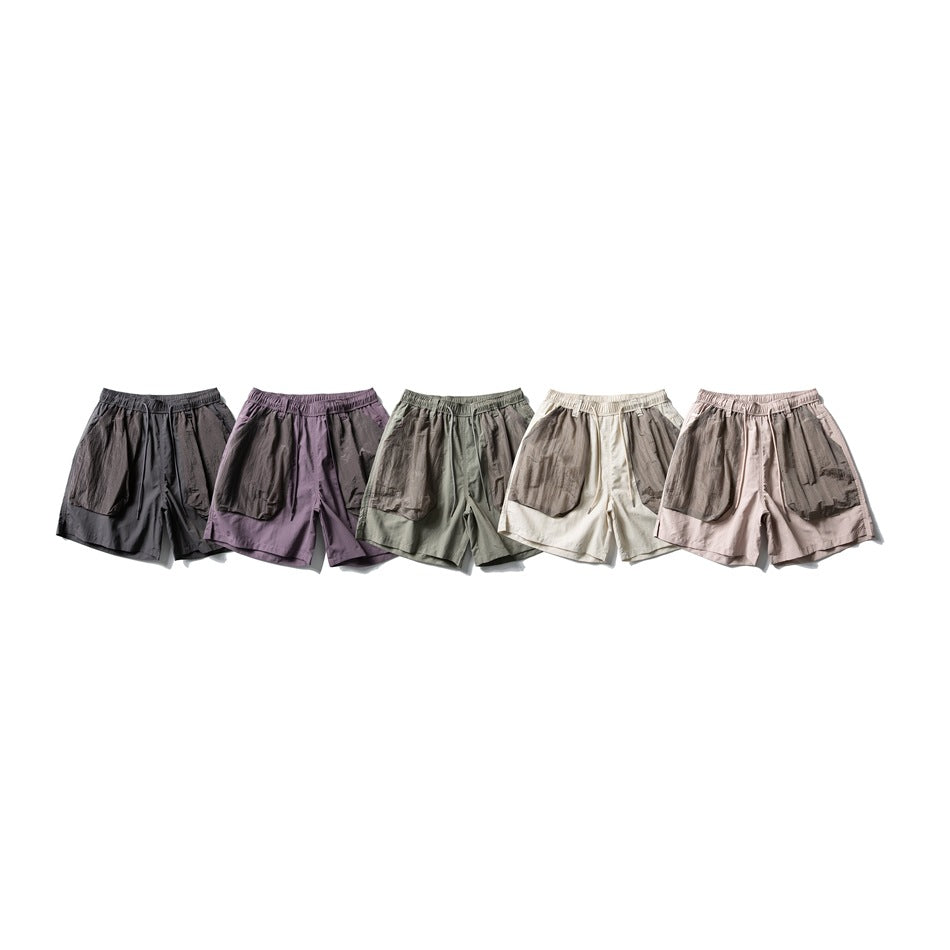 Five pairs of shorts displayed side by side in charcoal, purple, sage, cream and pale pink colorways.