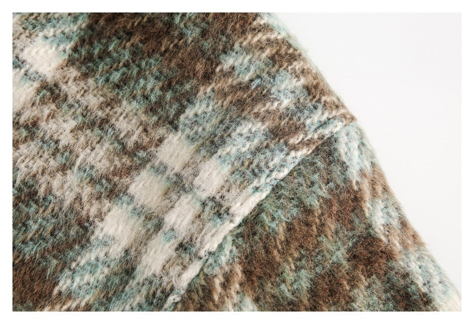 Close-up showing the jacket’s fuzzy plaid fabric in brown, cream and muted teal.