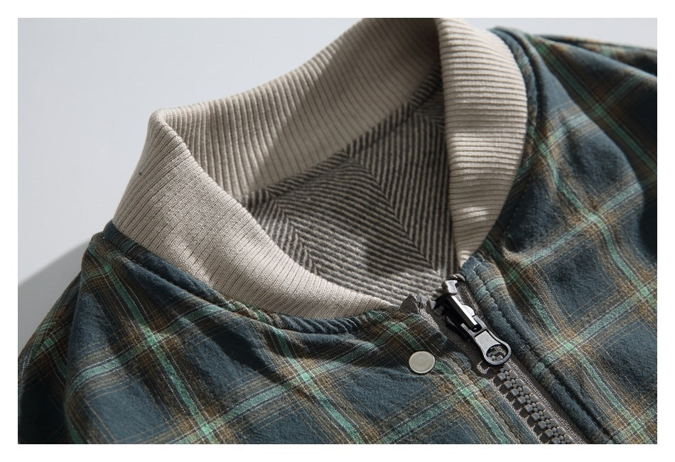 Close-up of the jacket's cream ribbed collar, striped inner lining, zipper, and snap.