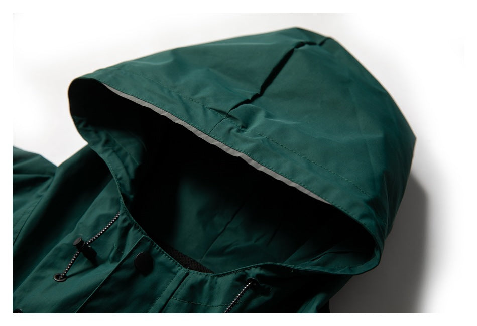 Close-up of the dark teal jacket's large hood, with light trim along the edge and drawcord hardware at the neckline.
