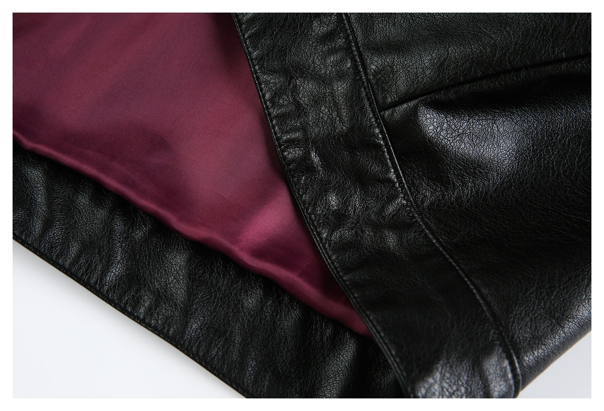Close-up of a black jacket opened to reveal burgundy lining and a leather-look front edge.
