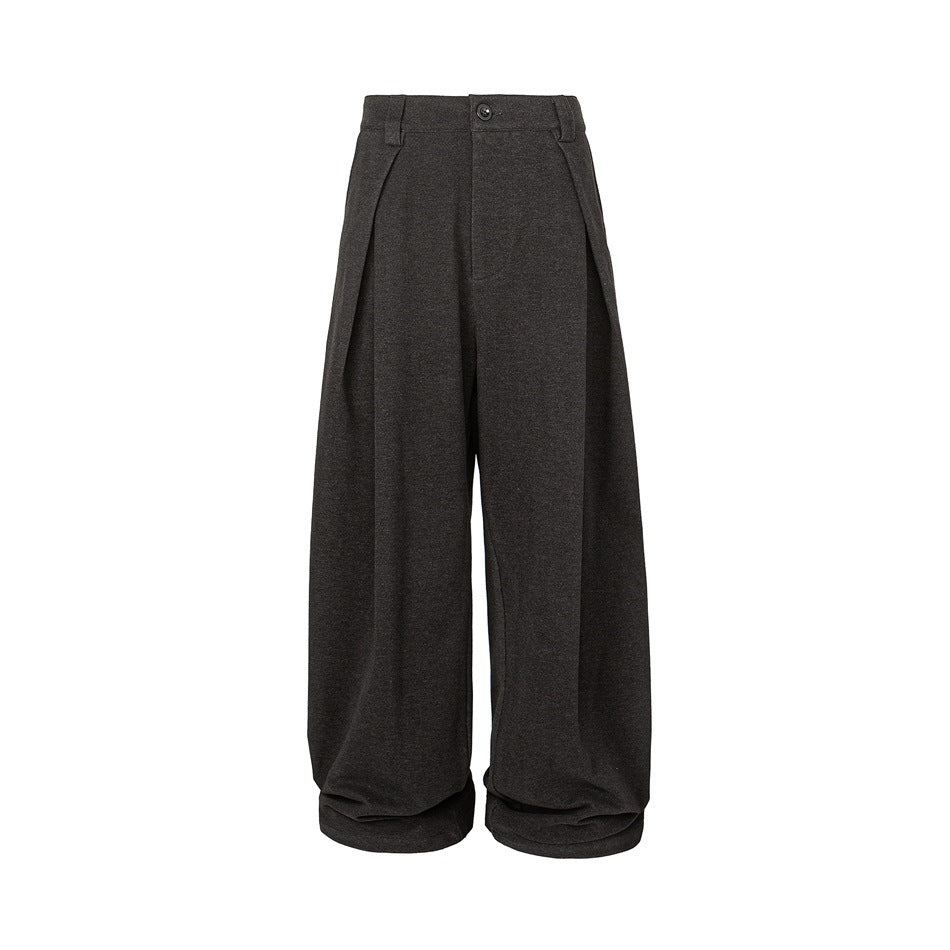 Front view of charcoal wide-leg trousers with a button waist, pleats and deep folds.