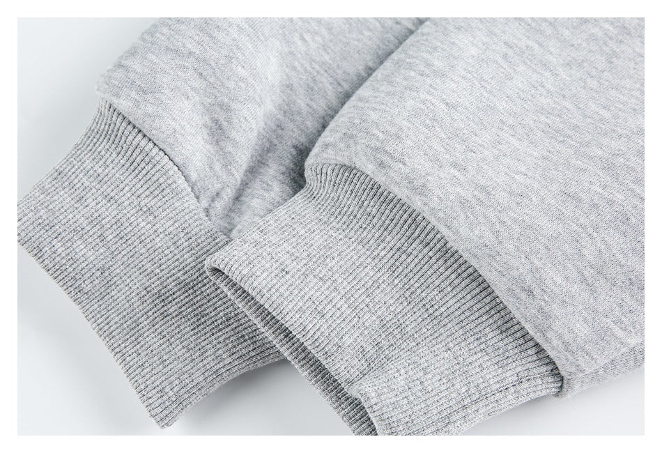 Close-up of a light gray sweatshirt with a wide ribbed knit cuff.