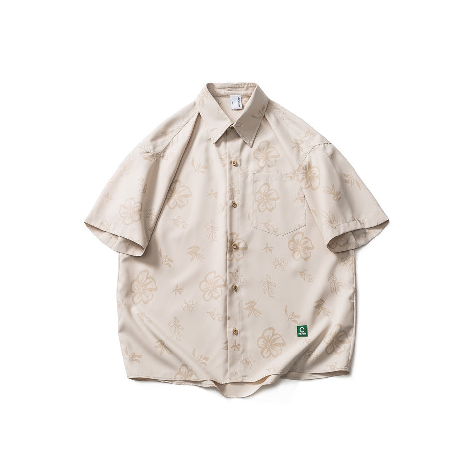 Khaki short-sleeve button-up shirt with tonal floral print, chest pocket and small green label, flat lay front view