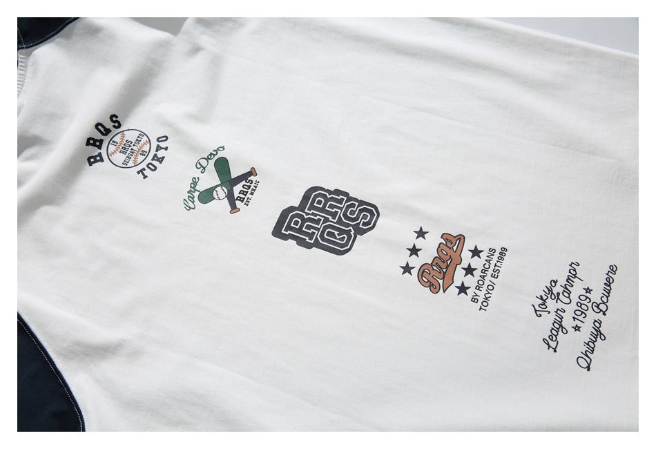 White fabric with several printed varsity-style graphics and lettering in black, green, and brown.