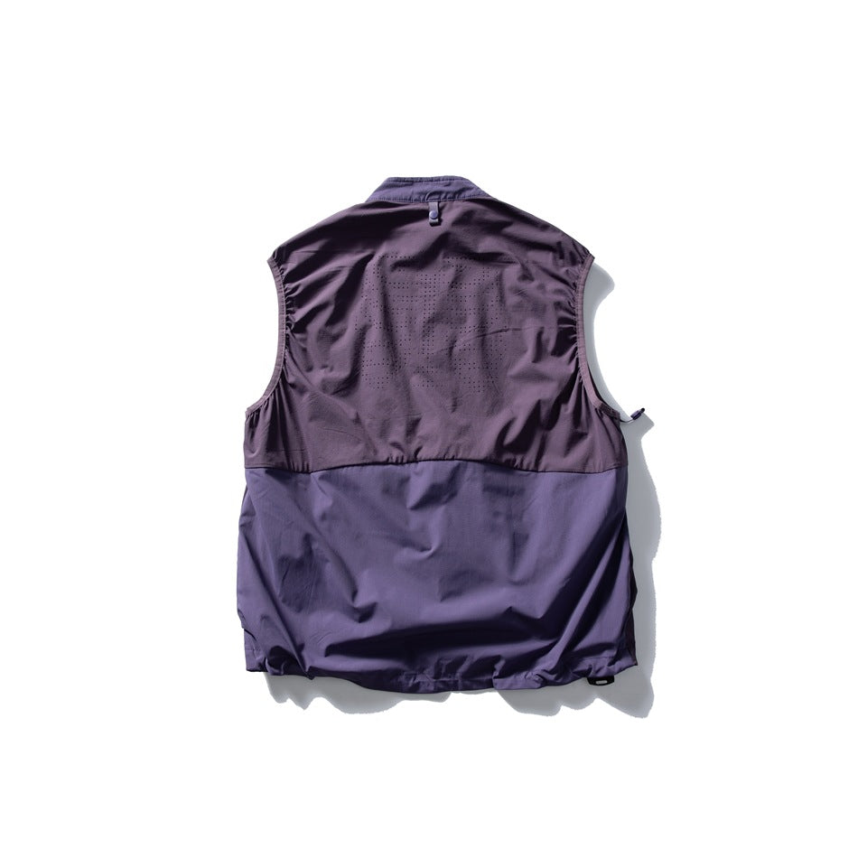 Back view of a plum-purple sleeveless vest with perforated upper-back panels and a solid lower panel.