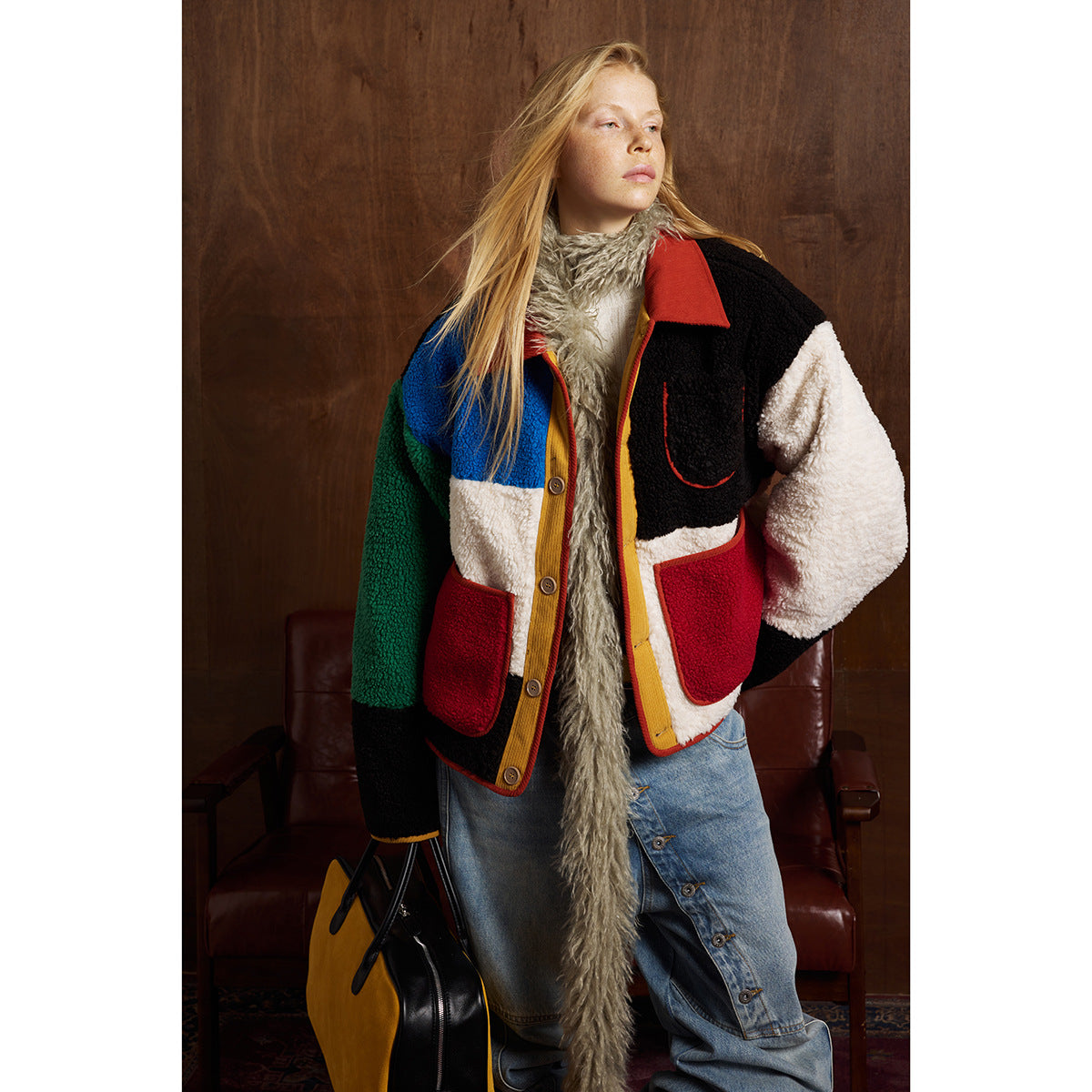 Model in a color-block jacket with red pockets, shown from the front with baggy jeans.