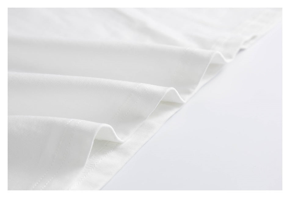 Close-up of a white shirt's folded hem and parallel stitching.