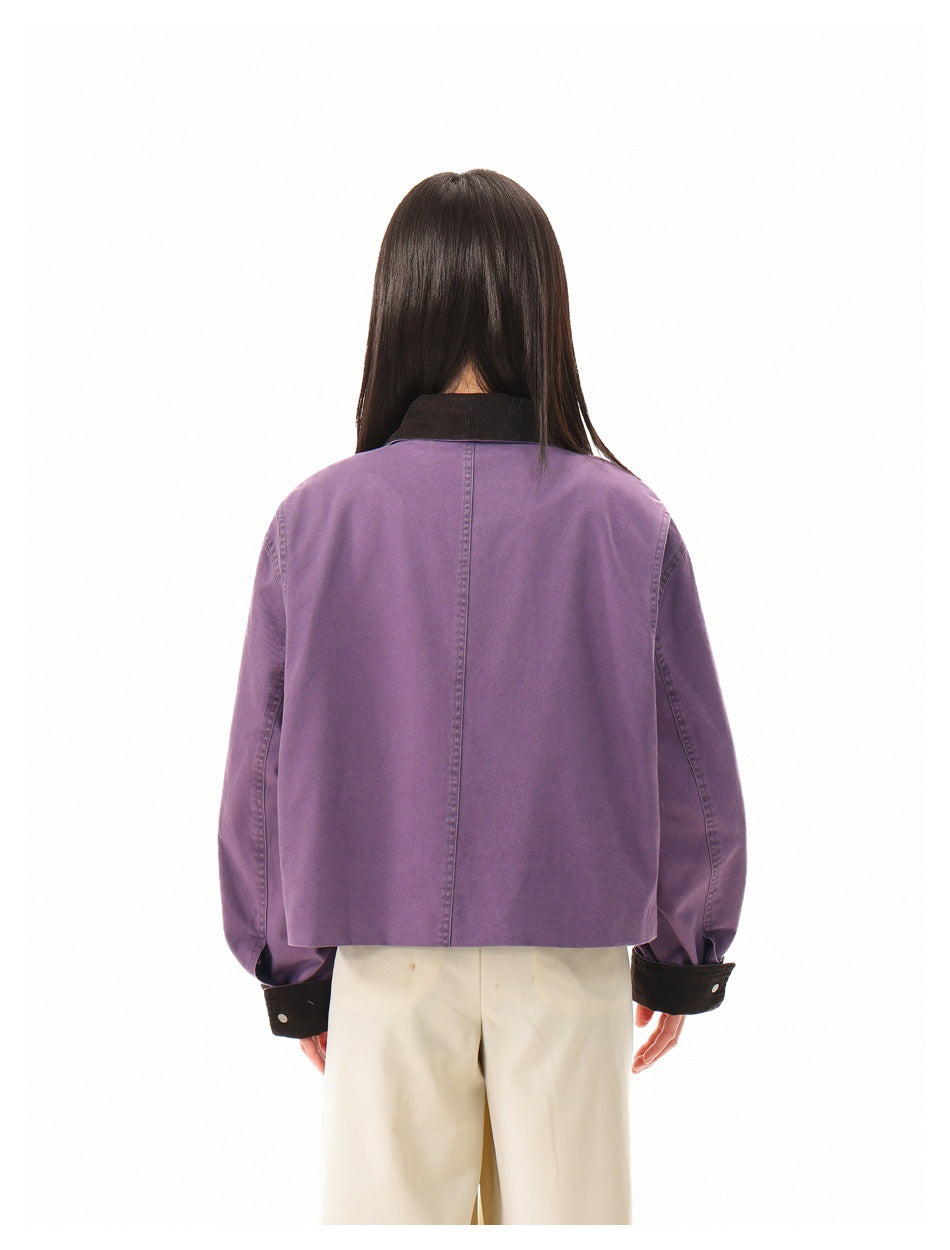 Rear view of a model wearing a purple cropped jacket with a dark collar and cuffs.